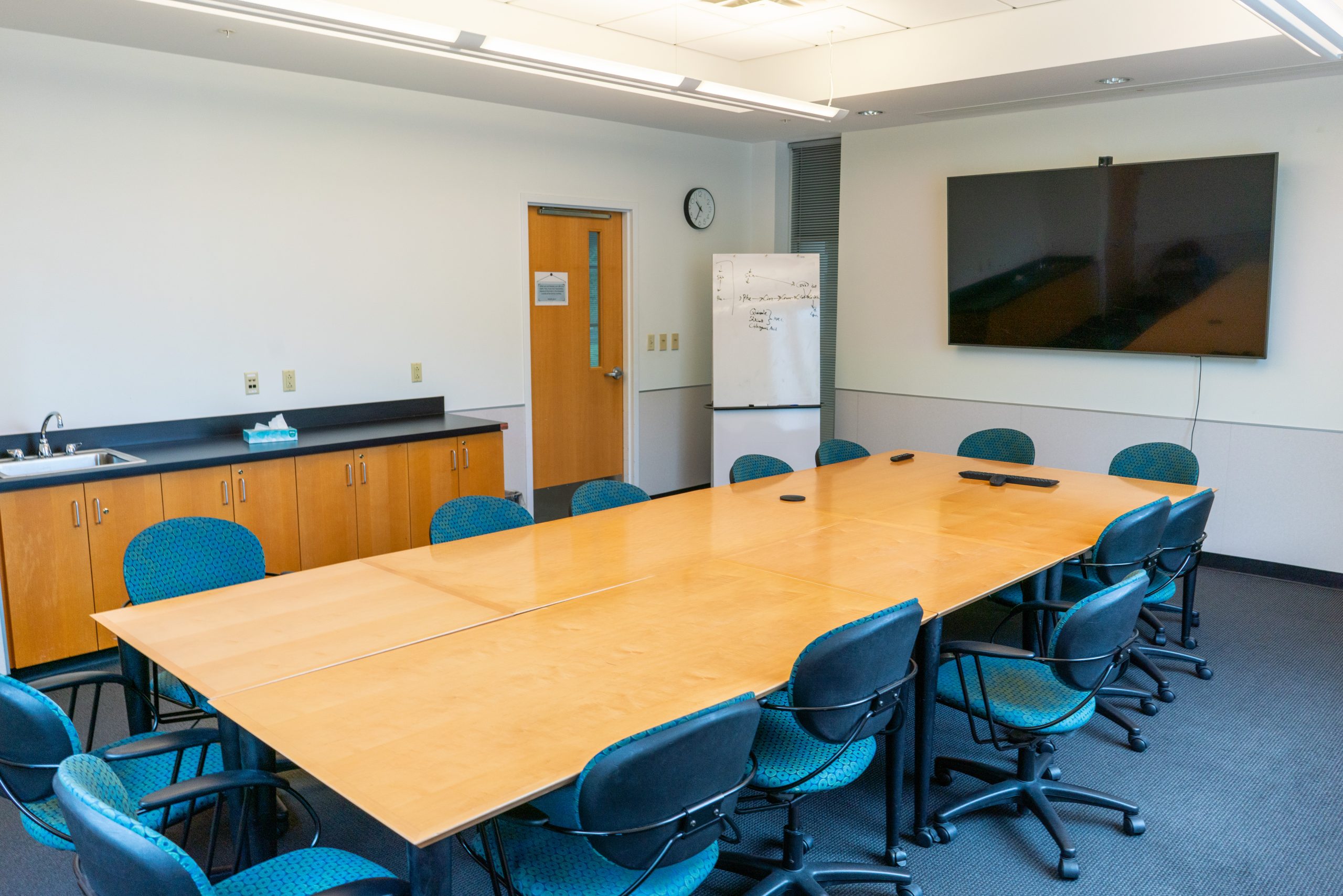 Meeting room with chairs, table and television