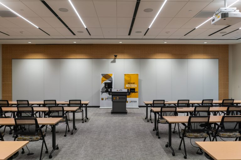 Desks and chairs and a podium set up in the Atkins Room