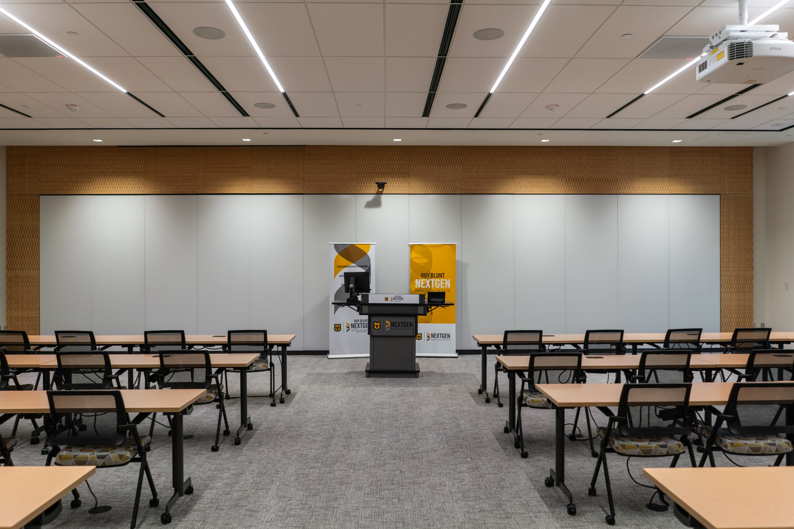 Desks and chairs and a podium set up in the Atkins Room