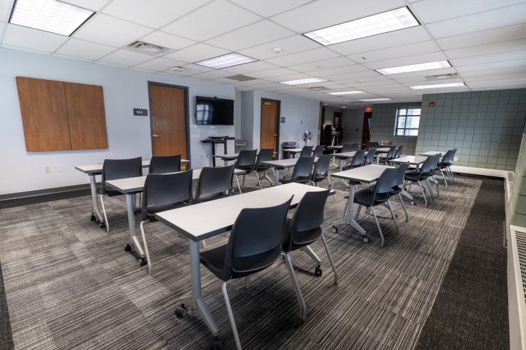 Desks and chairs set up in a small meeting room