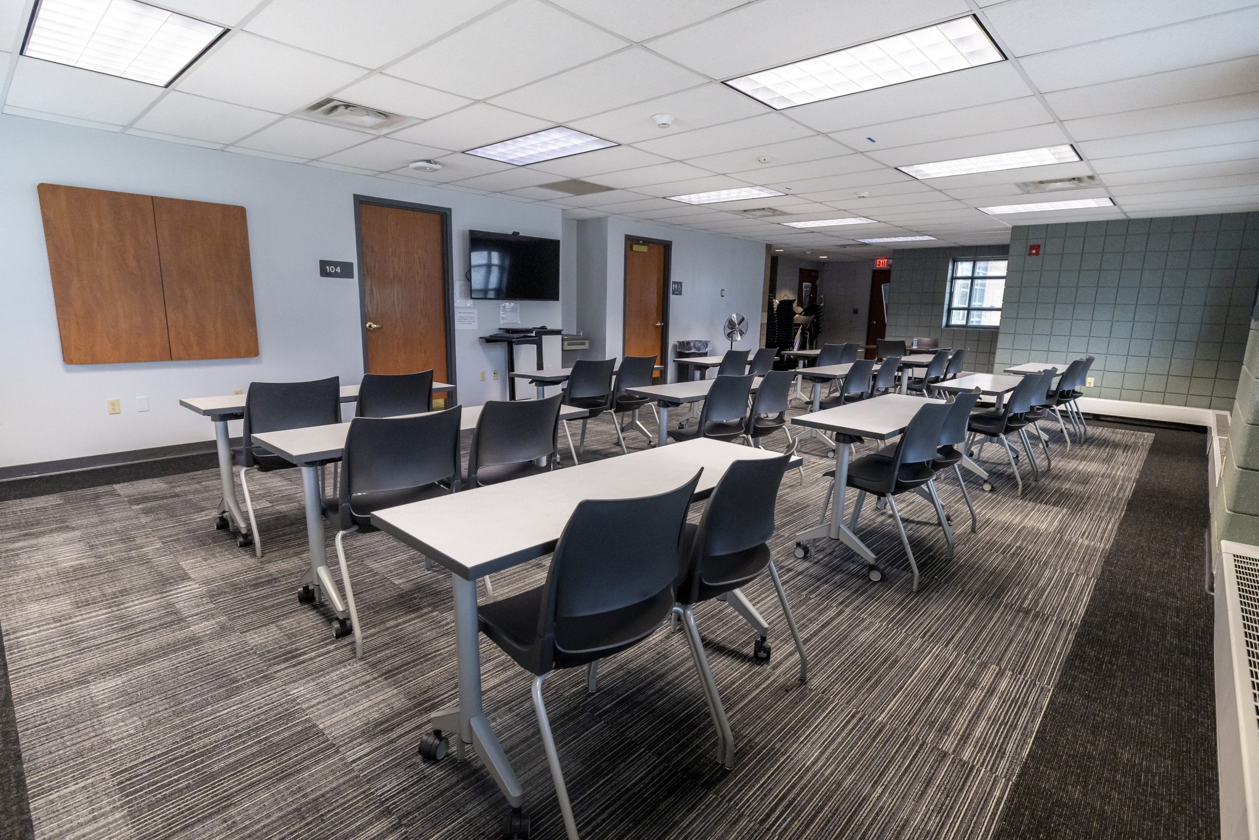 Desks and chairs set up in a small meeting room