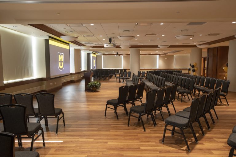 Conference room space with chairs and projector system
